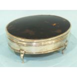 A silver and tortoiseshell trinket box of oval form, raised on four cabriole legs, London 1916,