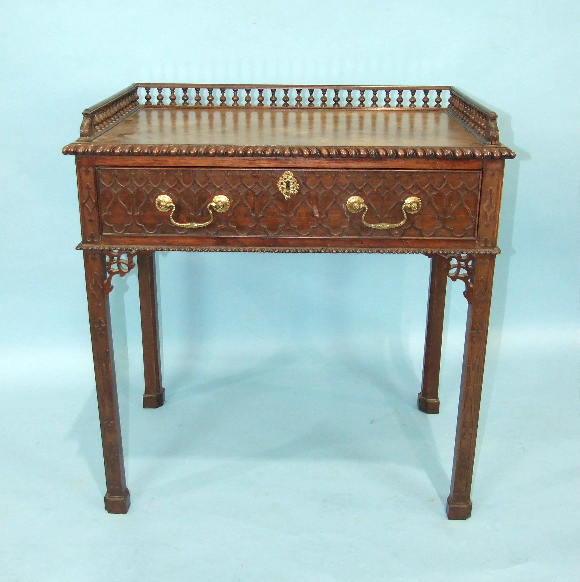 A good quality mahogany side table in the Chippendale taste, the rectangular galleried top above a