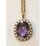 An amethyst and pearl cluster pendant claw-set an oval faceted amethyst within a border of