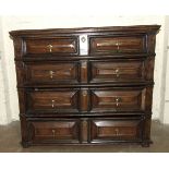 A 17th century Continental oak and hardwood chest of two short and three long panel-fronted drawers,