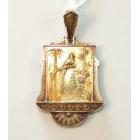 A Victorian Aesthetic Movement gold pendant of Japanese style, with an exotic bird and bamboo in
