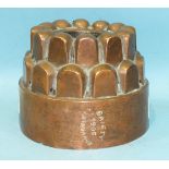 An early-20th century circular two-tier castellated copper jelly mould with impressed name 'Gaiety