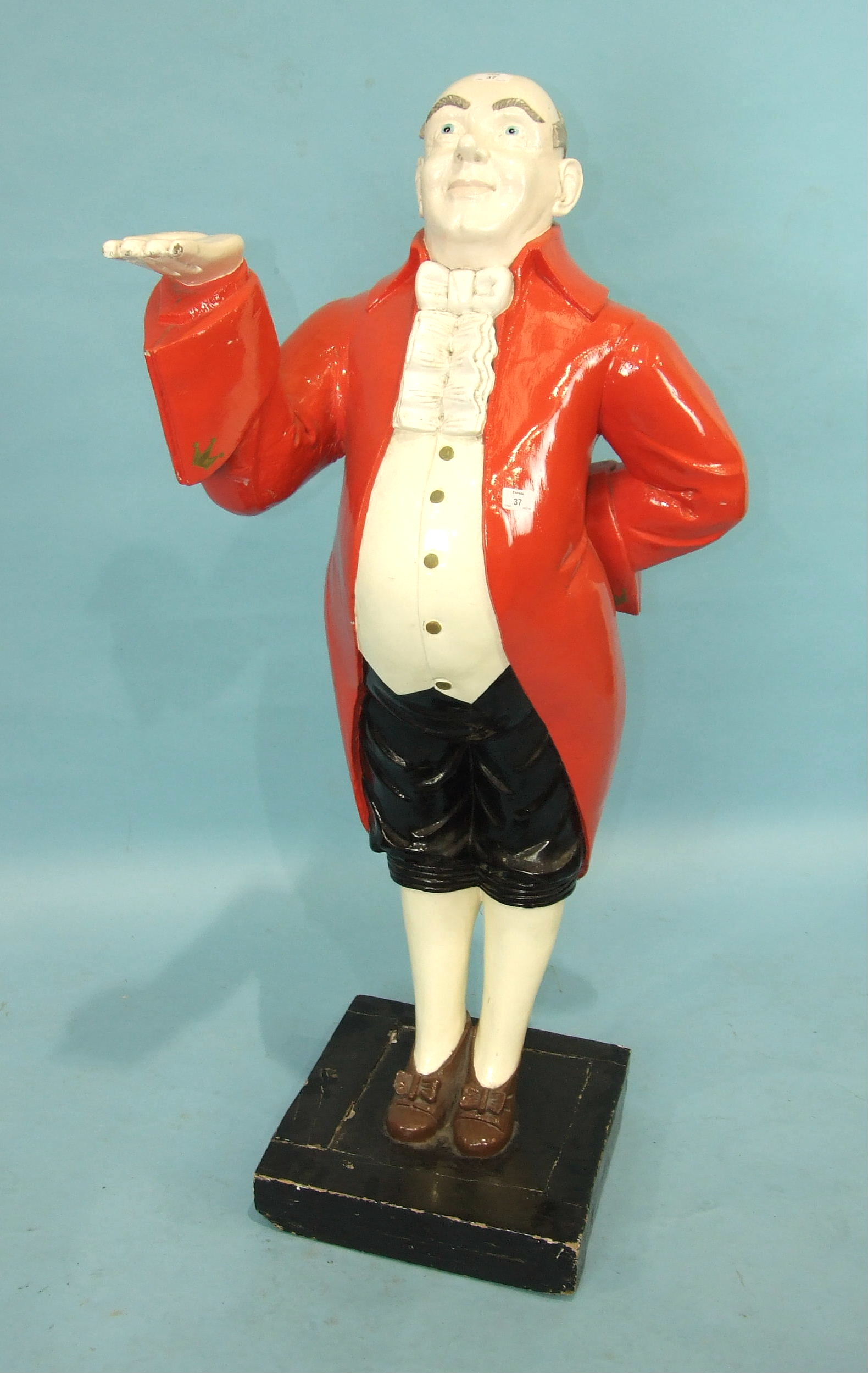 A 20th century dumb waiter in the form of a painted wood figure of a portly gentleman in red