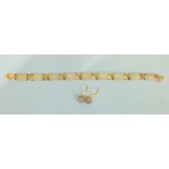 A modern Chinese jade bracelet of nine curved plaques with 14ct yellow gold mounts, 19cm long, 11g