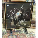 An early 20th century ebonised folding occasional table, the top with needlework panel depicting a