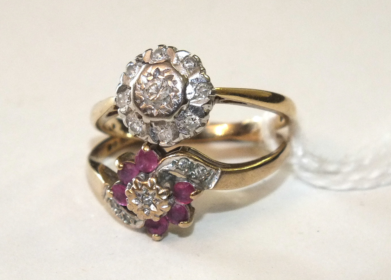 An 18ct gold ring set a diamond cluster, size L, 2.8g and a small ruby and diamond cluster 9ct
