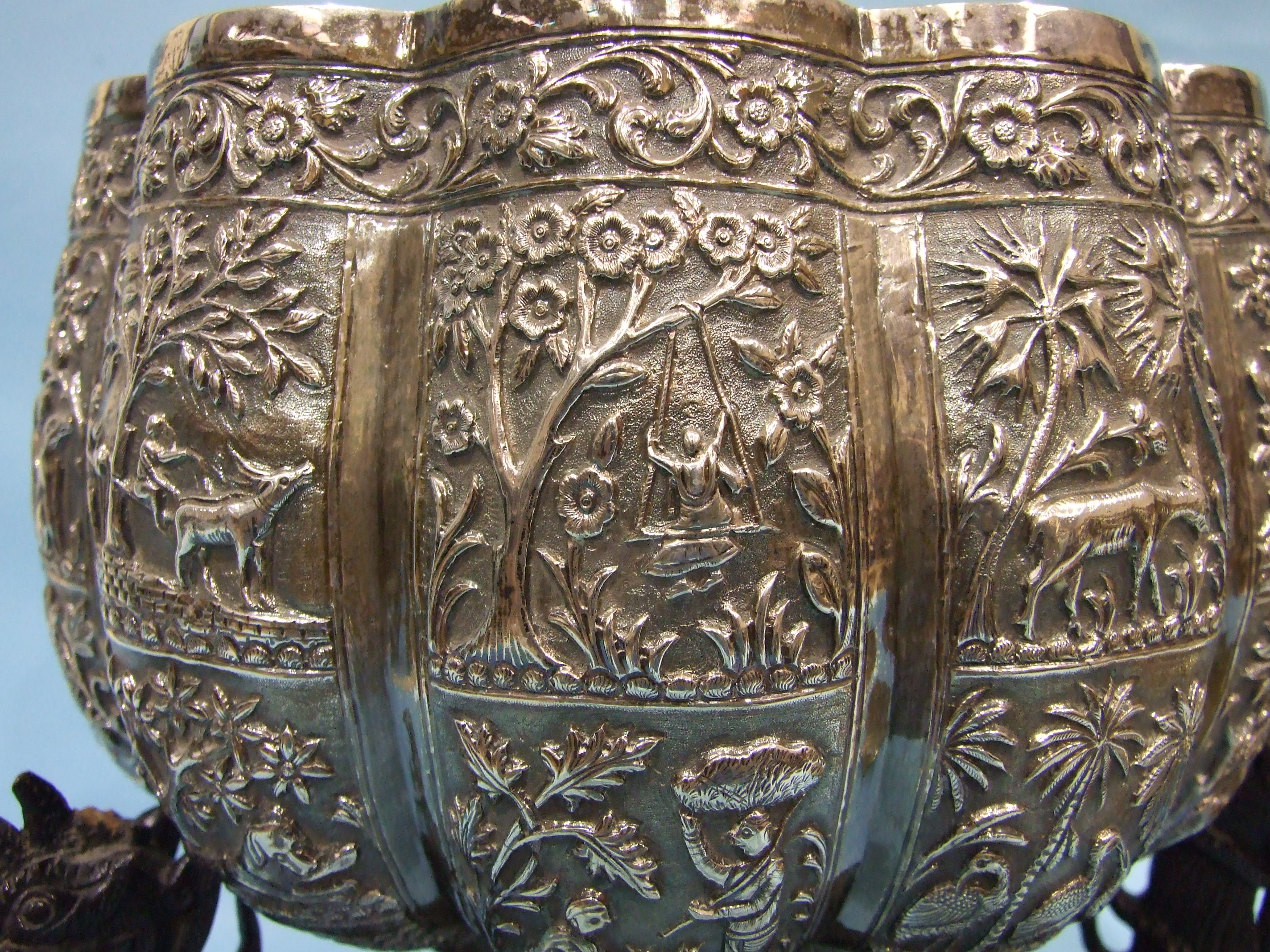 A large late 19th century Burmese white metal bowl of lobed form embossed with panels of figures, - Image 3 of 3