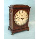 A Regency mahogany bracket clock, the case with brass detail, pierced side panels, carrying