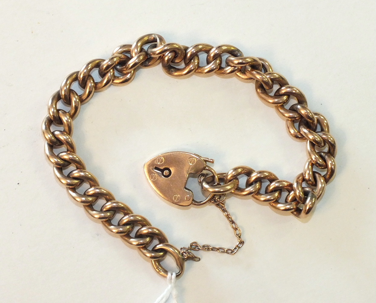 A 9ct rose gold curb-link bracelet with padlock clasp, 15.4g.