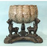 A large late 19th century Burmese white metal bowl of lobed form embossed with panels of figures,