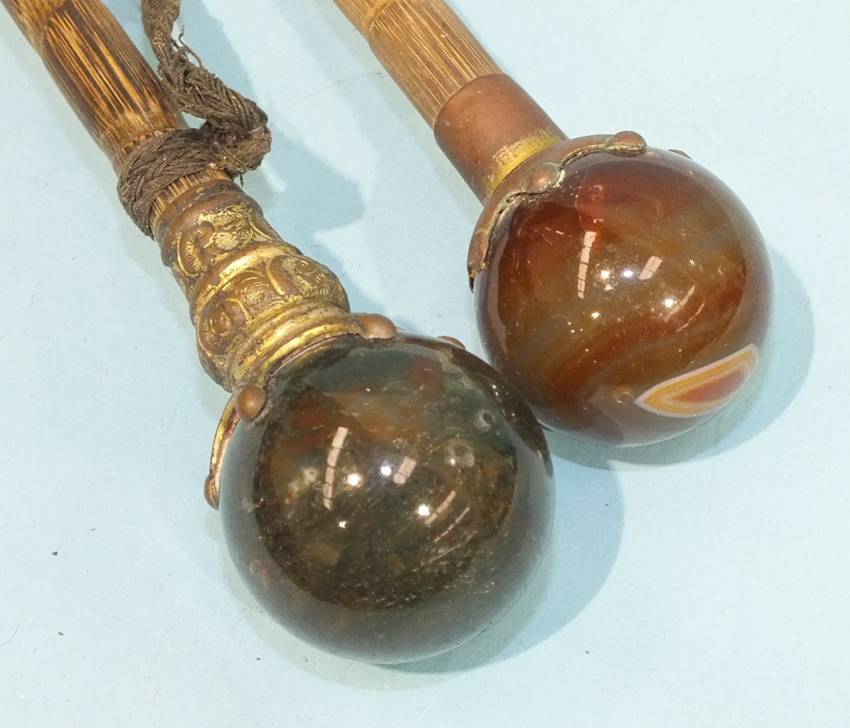 Two Late-Victorian umbrellas with gilt metal and agate ball handles and other sticks.