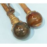 Two Late-Victorian umbrellas with gilt metal and agate ball handles and other sticks.