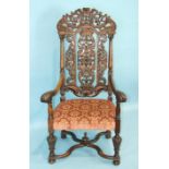 A 17th century Flemish carved walnut armchair in the style of Daniel Marot, with foliate pierced