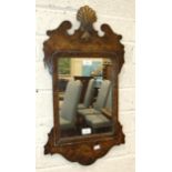 An 18th century grained wood and parcel gilt wall mirror with later plate, the back incised '