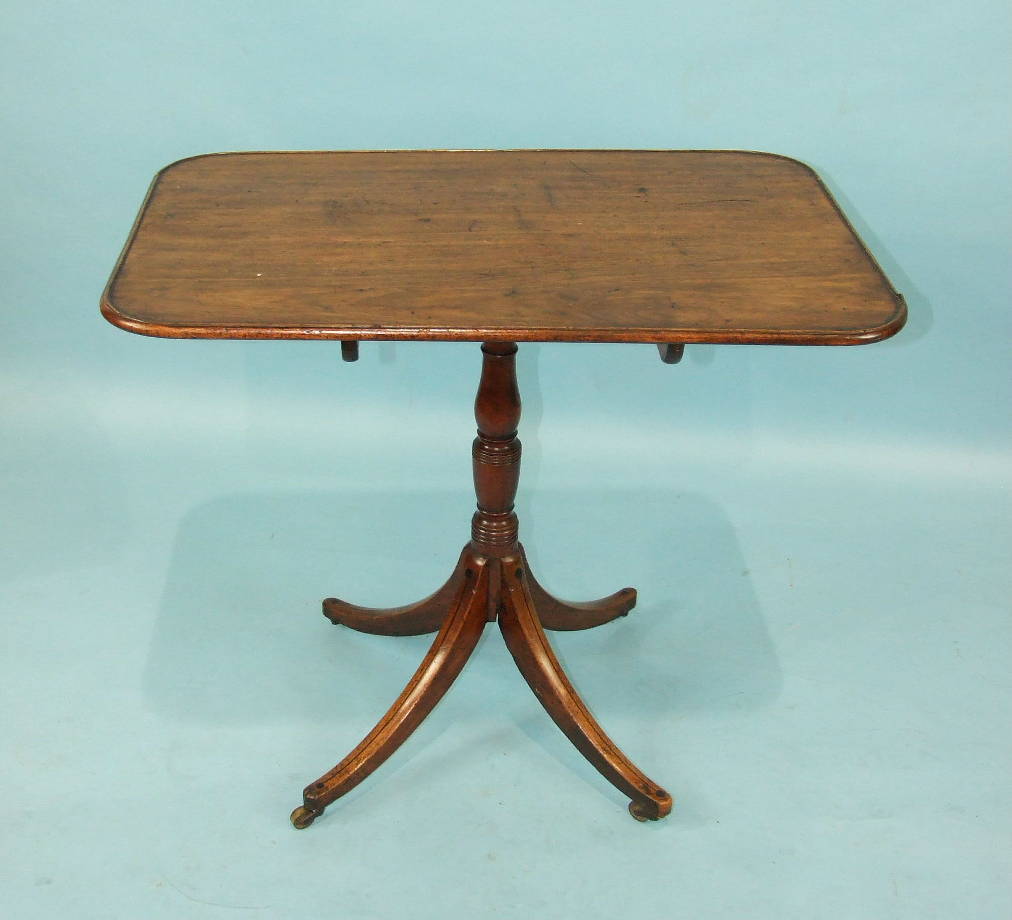 An early 19th century mahogany occasional table, the top with moulded edge, baluster column and