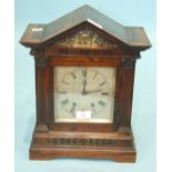 A 19th century walnut mantel clock of architectural form with 16cm silvered dial and French gong-