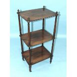 A 19th century rosewood three-tier whatnot on turned supports and castors, 46cm wide, 95cm high, (