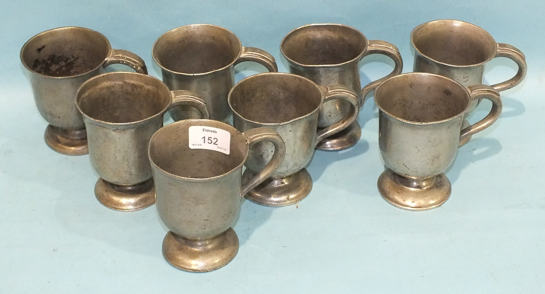 A collection of eight Victorian half-pint pewter frosted tankards with C-scroll handles, 11cm