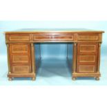 An Empire-style mahogany partner's desk with overall brass mouldings, the rectangular top above