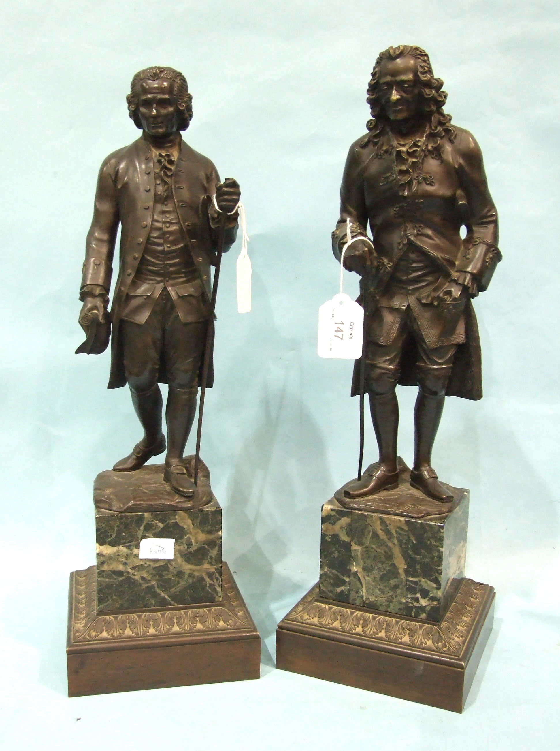 A pair of 19th century French bronze figures after Jean-Claude Rosset of Voltaire and Rousseau, each