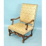 An antique Continental walnut armchair with upholstered back and seat, on Carolean carved legs and