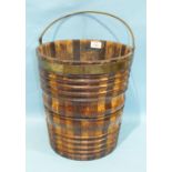 An 18th century tapered coopered peat bucket with specimen wood staves of reeded and shaped outline,