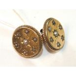 A pair of Victorian earrings, each of disc form set demi-pearls within beaded and rope-twist border,
