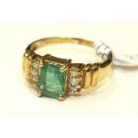 A 9ct gold ring set an emerald and six brilliant-cut diamonds, size P, 3.2g.