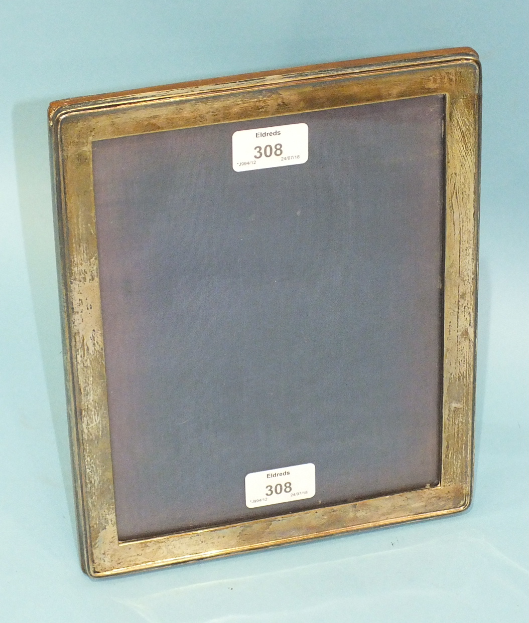 A silver photograph frame of plain rectangular form, Birmingham 1916, 26.5 x 21.5cm.