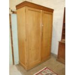 A stained pine two-door wardrobe, 123cm wide, 207cm high.