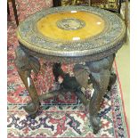 A late 19th/early 20th century carved hardwood circular table on elephant head supports, 69cm