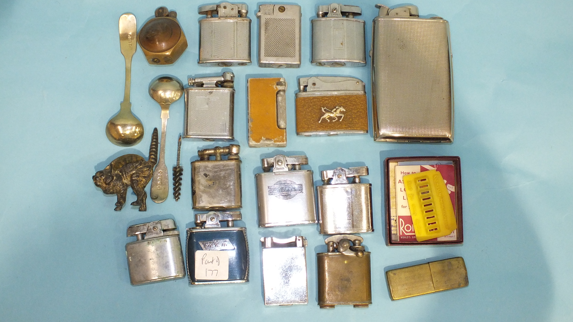 A collection of various cigarette lighters and miscellanea.