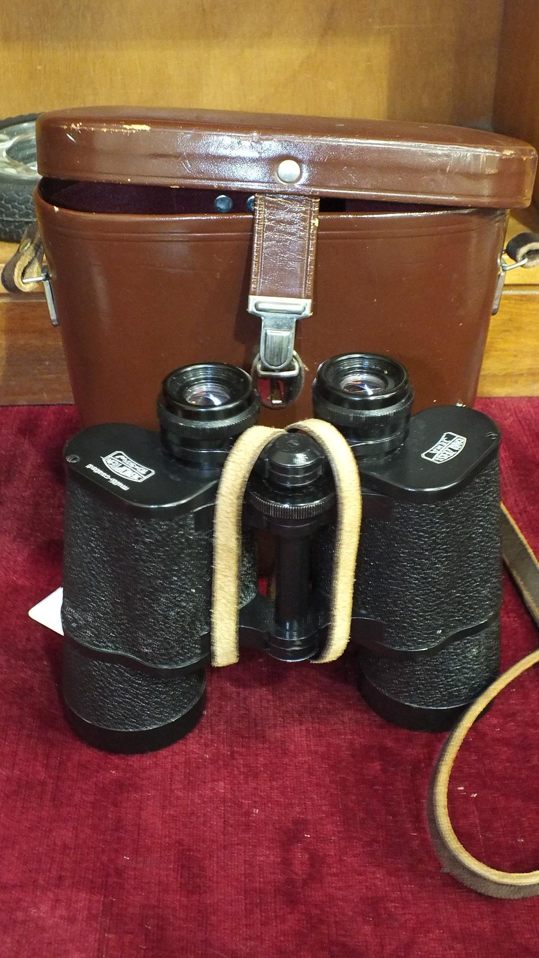 A pair of Carl Zeiss Jena Jenoptem 10x50W binoculars in leather case.