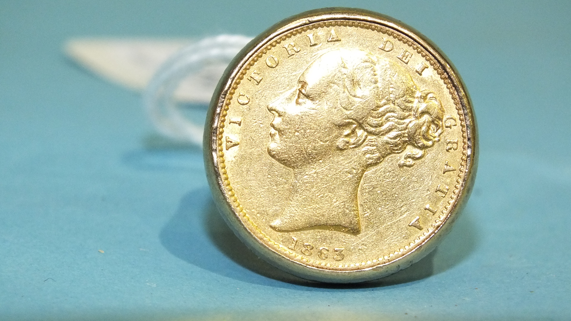 A sovereign ring set an 1863 sovereign, in 9ct gold mount, size V, 19.7g. - Image 2 of 2