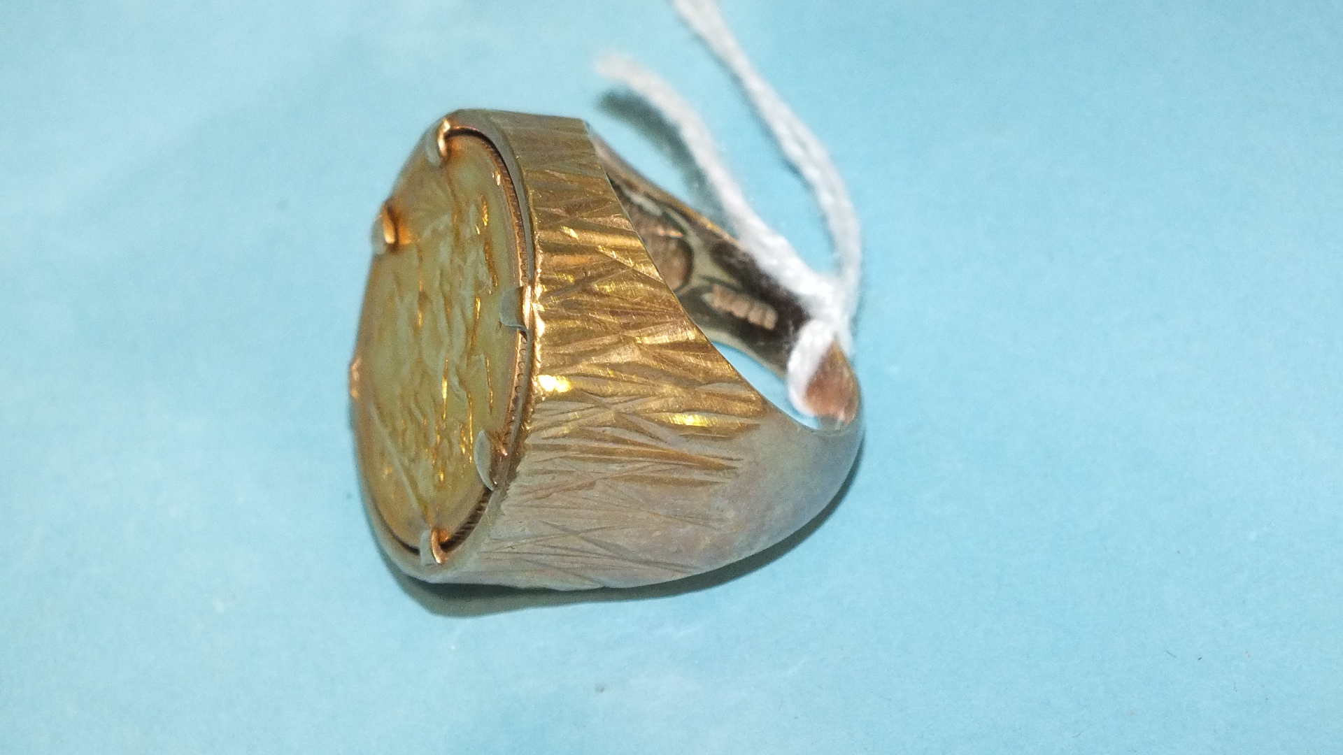 A sovereign ring set a 1911 sovereign, in 9ct gold mount, size O, 20.9g.