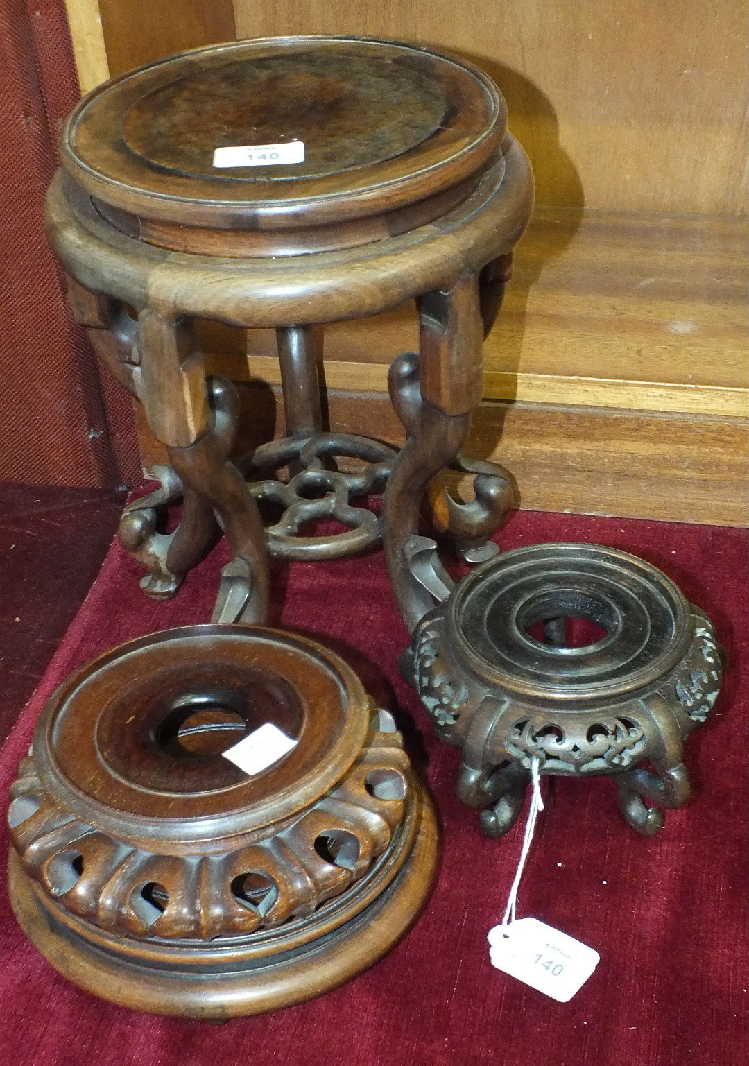 A Chinese carved hardwood jardinière stand, the circular burr wood top, 20cm diameter, on five