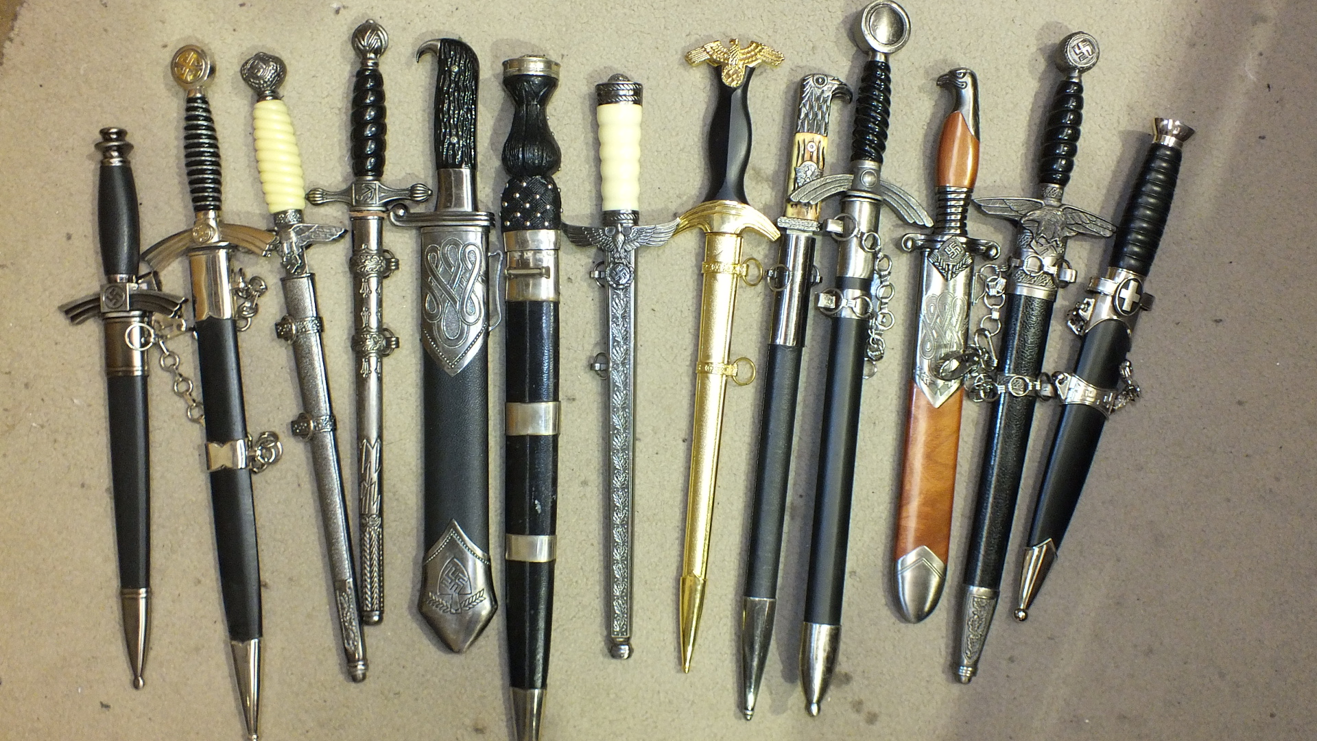 A collection of thirteen reproduction German military dirks and daggers, (13).