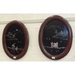 A pair of early-20th century Japanese lacquered and mother-of-pearl wall plaques, in oval frames, (