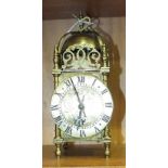 A 20th century brass lantern clock of typical form with French movement, 25cm high.