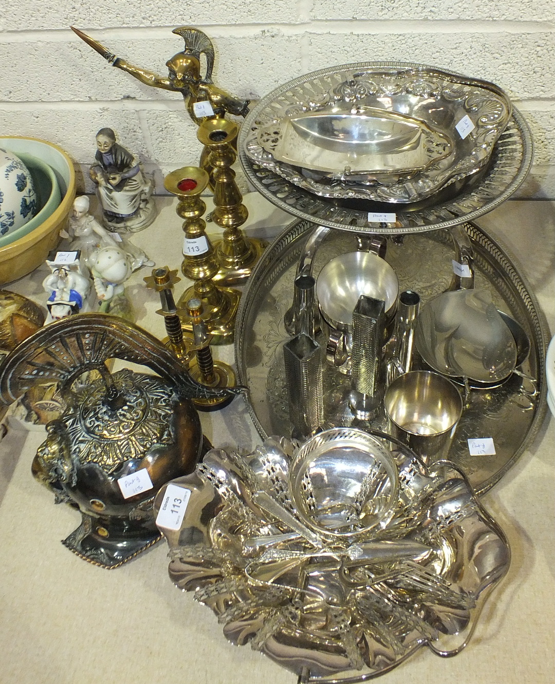 A plated oval galleried tray, other plated ware, a pair of brass candlesticks and various metal