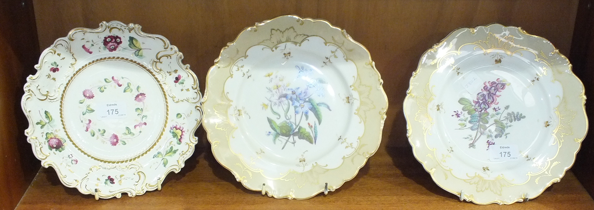 A pair of 19th century English floral painted porcelain plates, 23cm diameter and one other, (3).