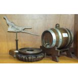 A small metal-coopered oak barrel with brass tap, on stand, 17cm long, an oriental hardwood stand,
