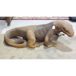 An Indonesian carved wood model of a Komodo dragon, 100cm long, 38cm high, (some losses to toes).