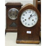 A mahogany mantel clock of arch form with gong-striking movement, 36cm high and an oak-cased