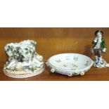 A 19th century German porcelain flower-encrusted posy holder supported by reclining cherubs, on