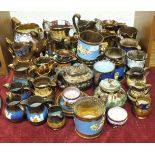 A collection of approximately thirty-five pieces of copper lustre and other jugs, tankards, etc.