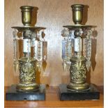 A pair of Victorian brass candle lustres, each with cut drops on black marble base, 25cm high, (