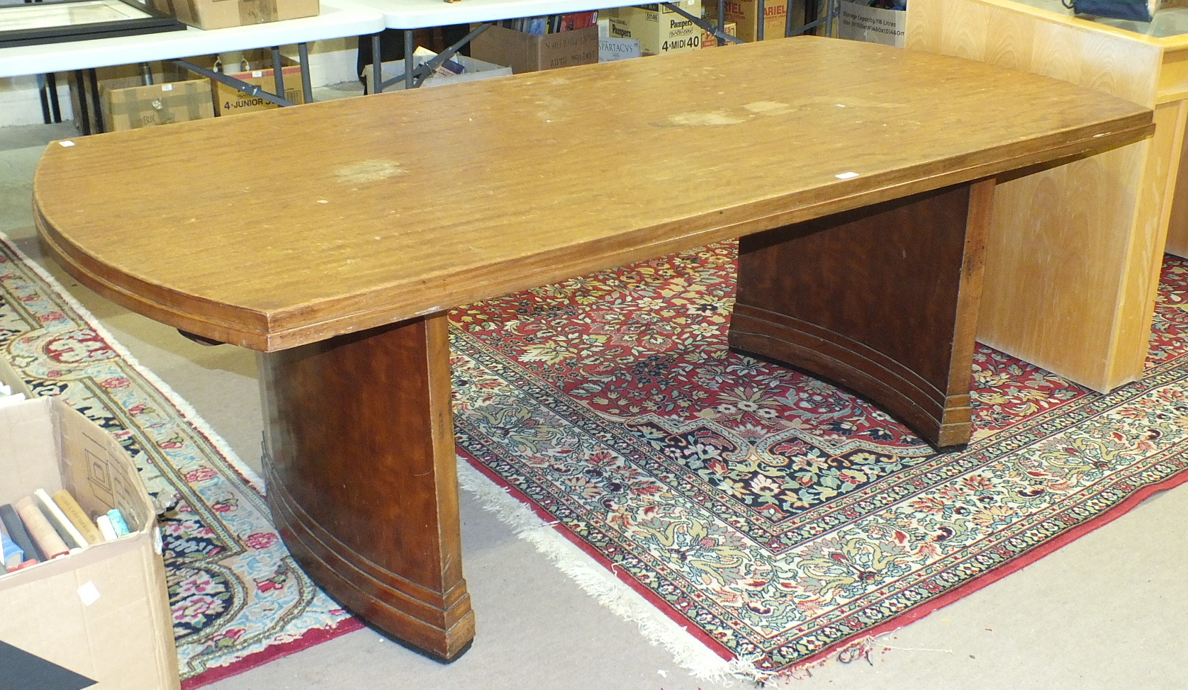 A large mahogany finish boardroom table with rounded ends and supports, 103 x 214cm, together with a