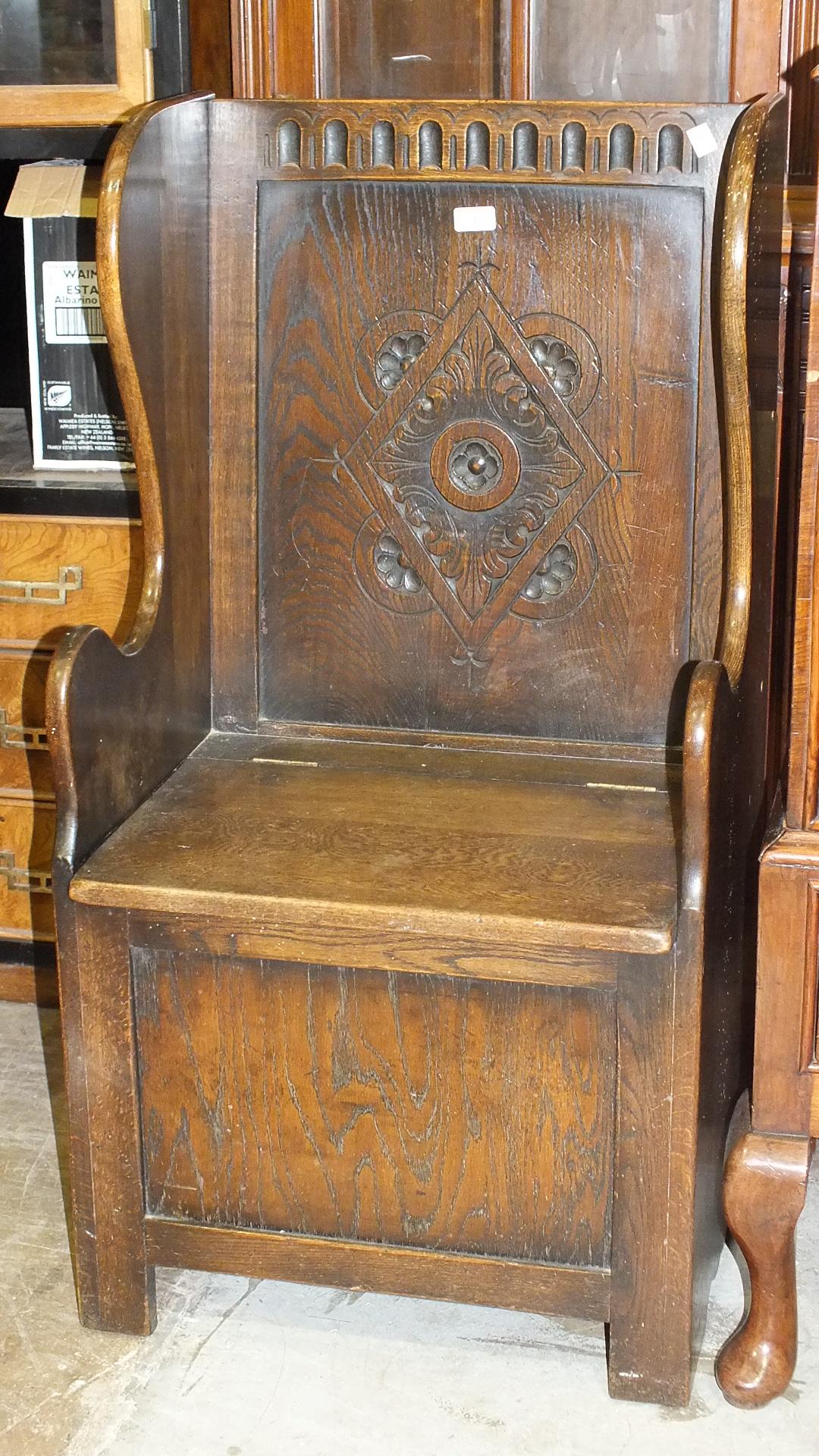 An oak hall seat with hinged seat, 55cm wide, 118cm high, (a/f), a small oak bureau on cabriole