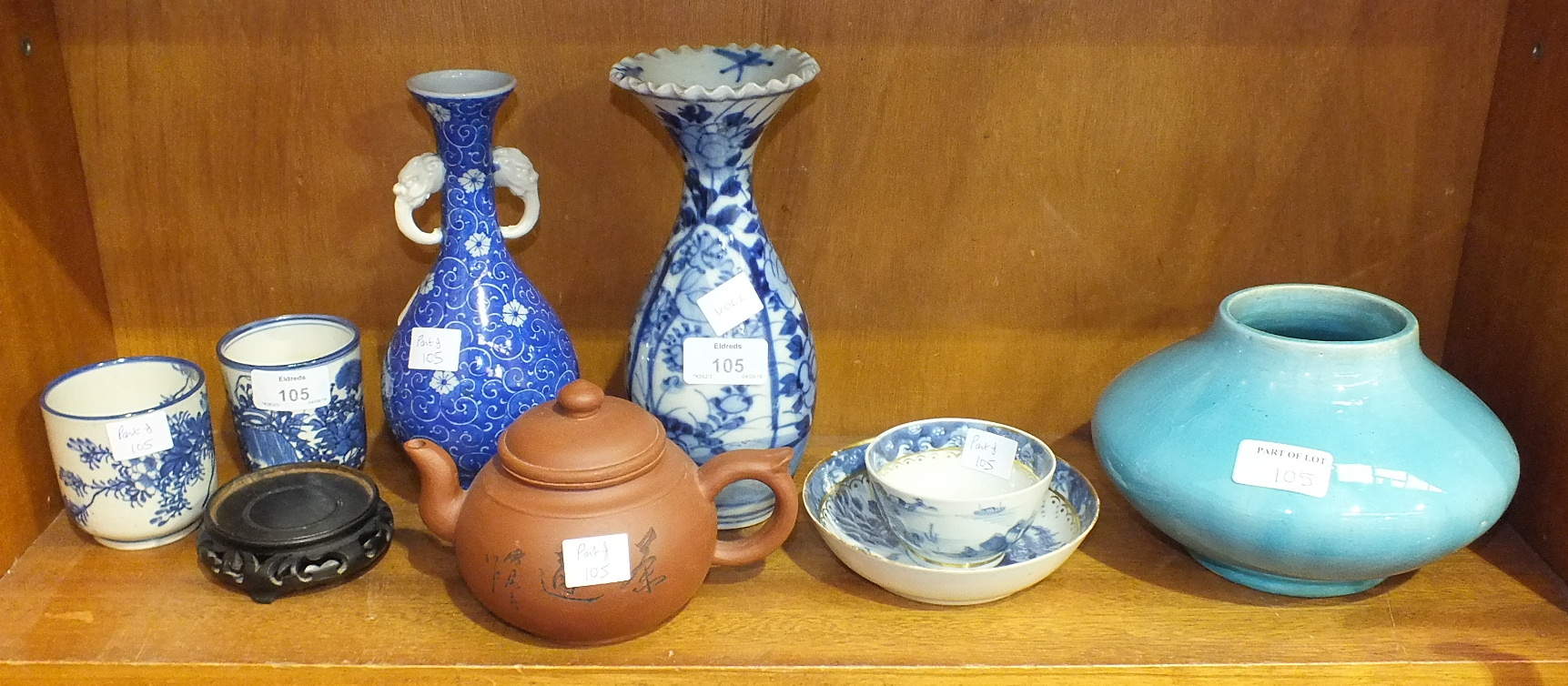 Two early-20th century Oriental blue and white baluster vases, a pale blue glazed pottery vase of